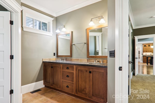 bathroom with vanity, ornamental molding, and tile patterned floors