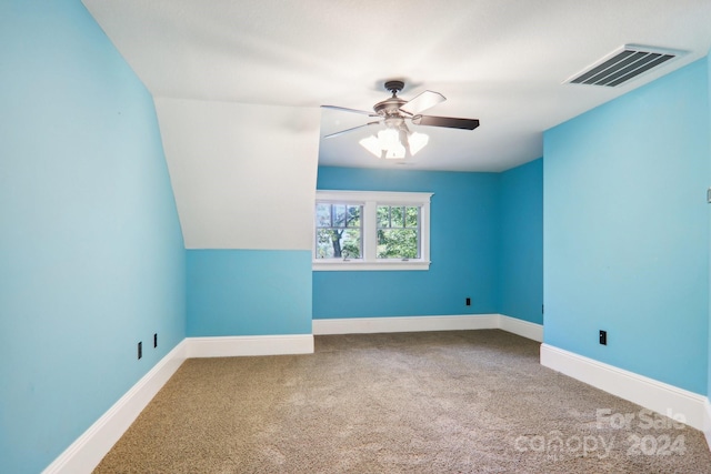 additional living space featuring ceiling fan, carpet, and lofted ceiling