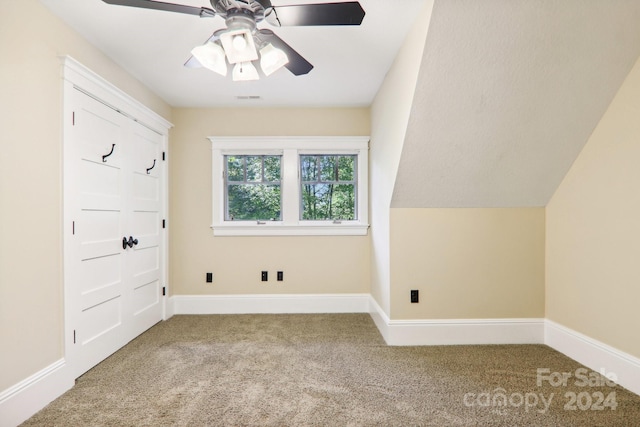 bonus room with lofted ceiling, carpet, and ceiling fan