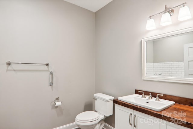 bathroom featuring toilet and vanity