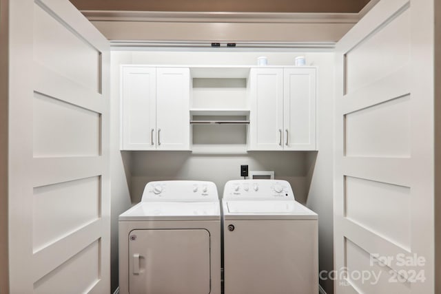 laundry room with independent washer and dryer and cabinets