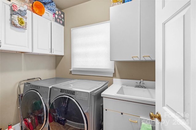 washroom featuring cabinets, sink, and separate washer and dryer