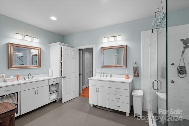 bathroom featuring vanity and a shower with shower door