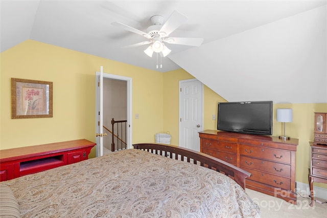 carpeted bedroom with vaulted ceiling and ceiling fan