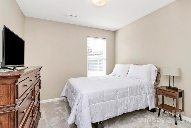 bedroom featuring light colored carpet