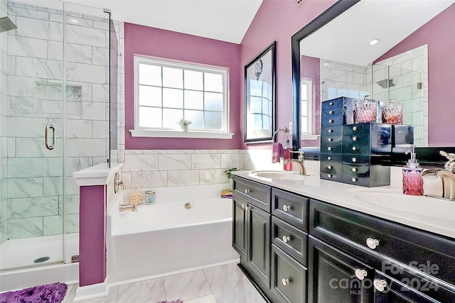 bathroom featuring vanity, separate shower and tub, and vaulted ceiling