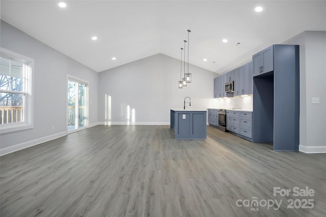 kitchen featuring pendant lighting, blue cabinets, a center island, and hardwood / wood-style flooring