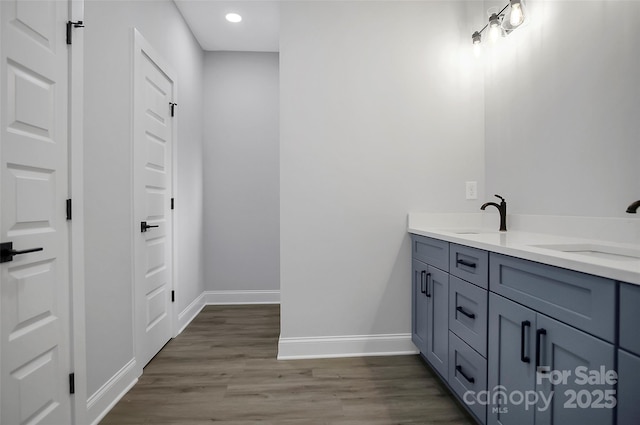 bathroom featuring vanity and hardwood / wood-style floors