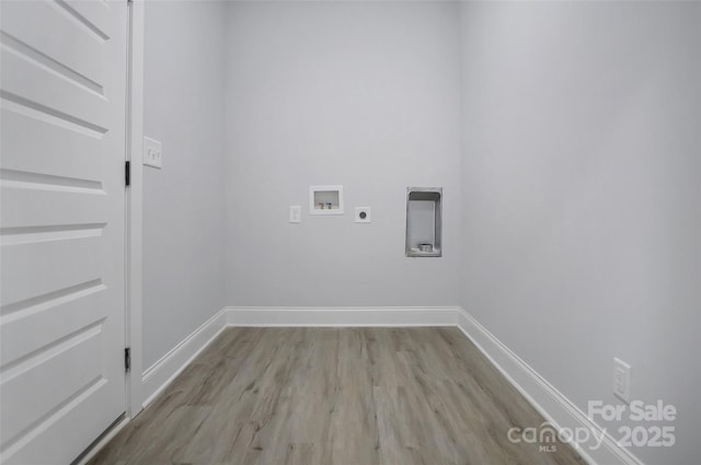 washroom with hookup for a washing machine, electric dryer hookup, and light wood-type flooring