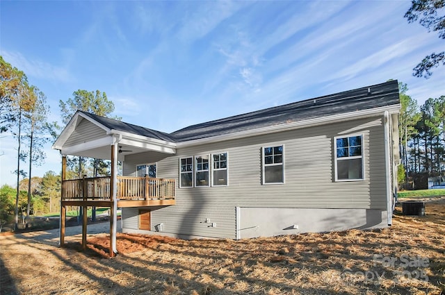 rear view of property with cooling unit, crawl space, and a deck