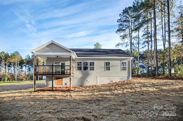 exterior space with a wooden deck and a ceiling fan