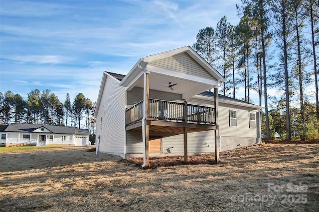 rear view of house featuring ceiling fan and a deck