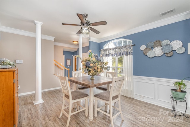 dining space featuring ornate columns, crown molding, light hardwood / wood-style floors, and ceiling fan