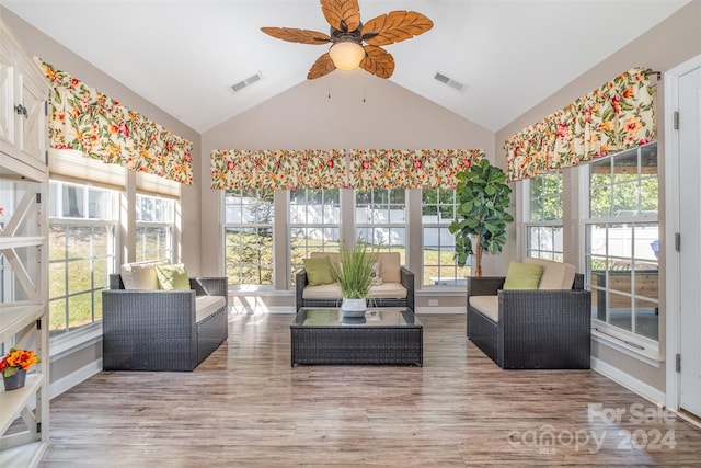 sunroom with vaulted ceiling, wood finished floors, and visible vents