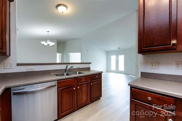 kitchen with dishwasher, sink, vaulted ceiling, a notable chandelier, and decorative light fixtures