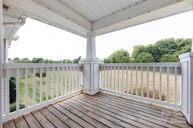 wooden terrace with a yard