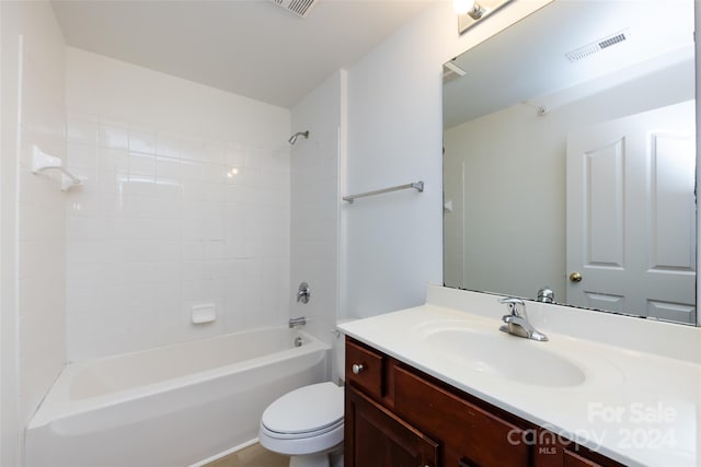 full bathroom featuring vanity, toilet, and tiled shower / bath combo