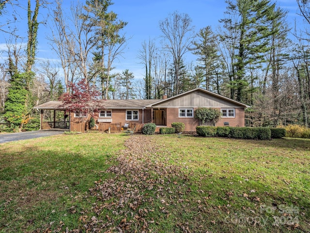 ranch-style house with a front yard and a carport