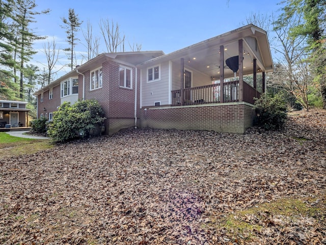 back of house featuring ceiling fan and covered porch