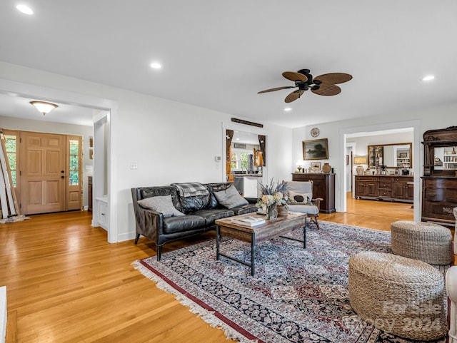 living room with light wood-type flooring and ceiling fan