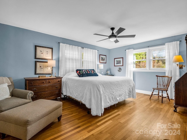 bedroom with hardwood / wood-style floors and ceiling fan