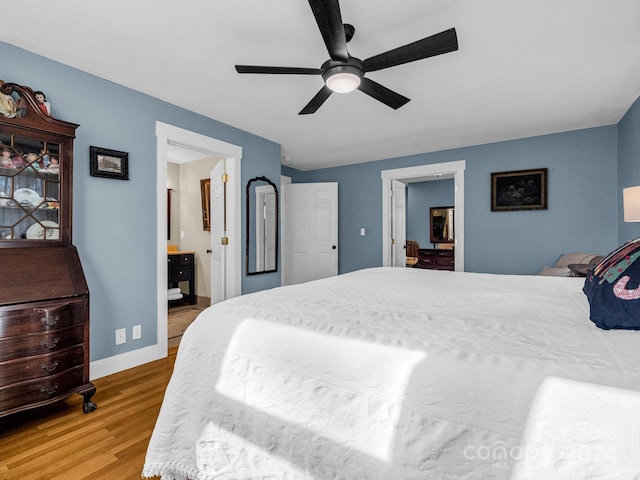 bedroom with ceiling fan, light hardwood / wood-style floors, and connected bathroom