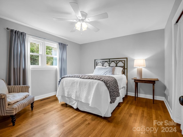 bedroom with ceiling fan and wood-type flooring