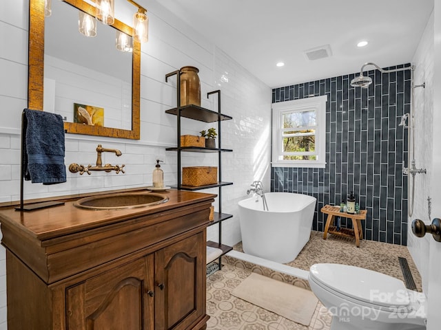 full bathroom with tile patterned floors, shower with separate bathtub, toilet, vanity, and tile walls