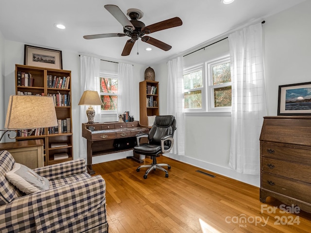 office space with ceiling fan and light hardwood / wood-style flooring