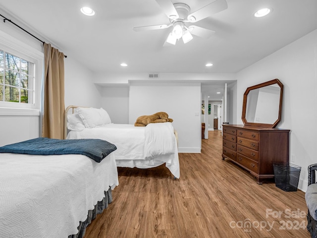 bedroom with ceiling fan and light wood-type flooring