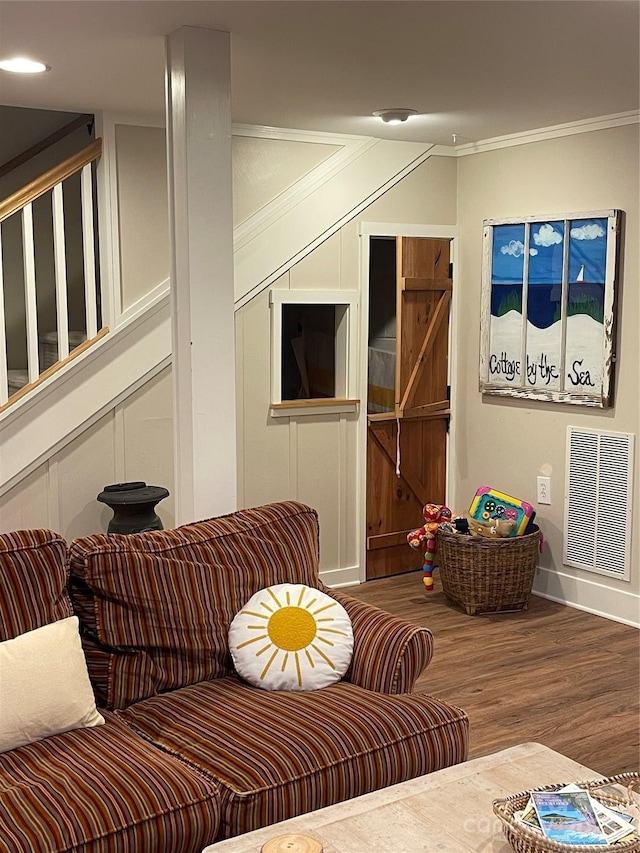 living room with hardwood / wood-style floors and ornamental molding