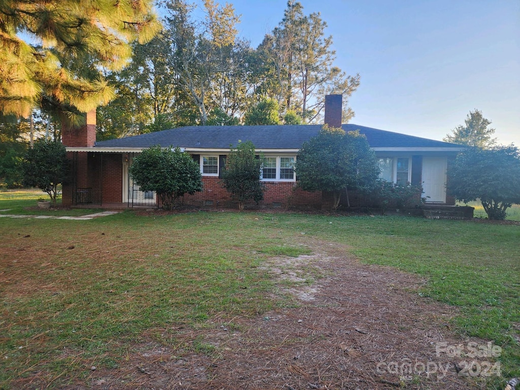 25606 Hwy 151, Mcbee, SC 29101 - ranch-style home with a front lawn, a chimney, and brick siding