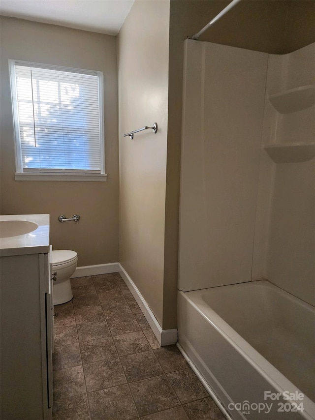 full bathroom with baseboards, toilet, vanity, and washtub / shower combination