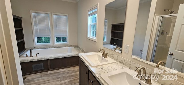 bathroom with crown molding, hardwood / wood-style floors, vanity, and shower with separate bathtub