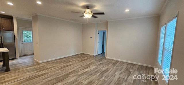 unfurnished room featuring ceiling fan, ornamental molding, and light hardwood / wood-style flooring