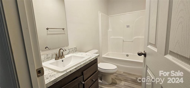 full bathroom with vanity, hardwood / wood-style flooring, toilet, and  shower combination