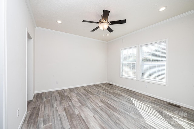 unfurnished room with a textured ceiling, light hardwood / wood-style flooring, ceiling fan, and ornamental molding