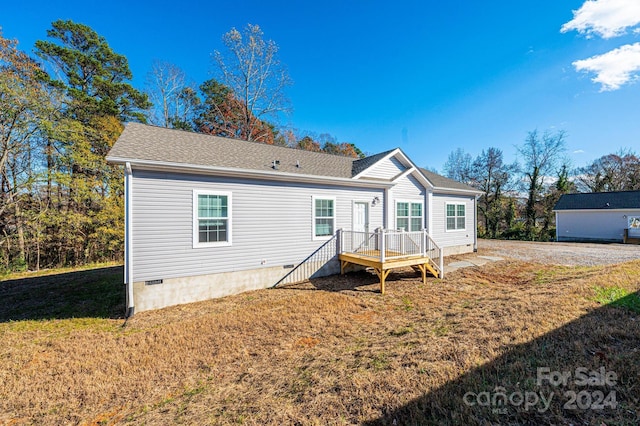 rear view of property featuring a lawn