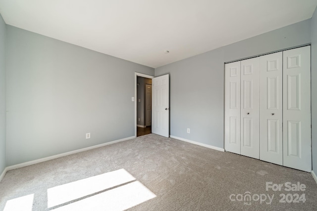 unfurnished bedroom featuring a closet and carpet