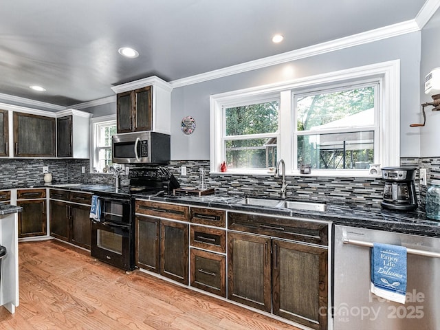 kitchen with plenty of natural light, sink, backsplash, and stainless steel appliances