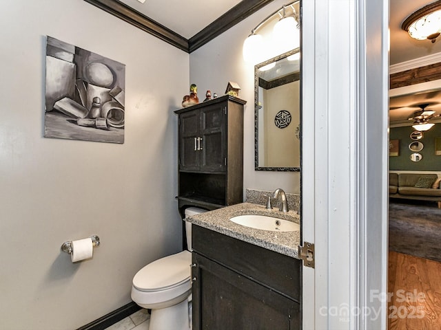 bathroom with vanity, ceiling fan, toilet, ornamental molding, and hardwood / wood-style flooring