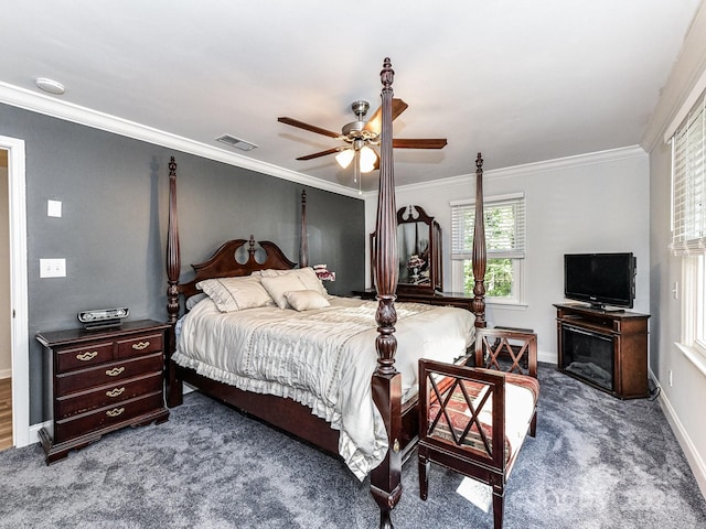 bedroom with ceiling fan, crown molding, and dark colored carpet