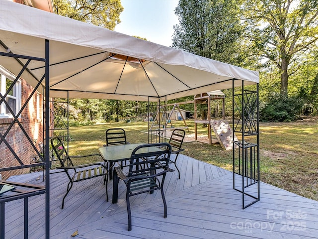 wooden terrace with a gazebo and a yard