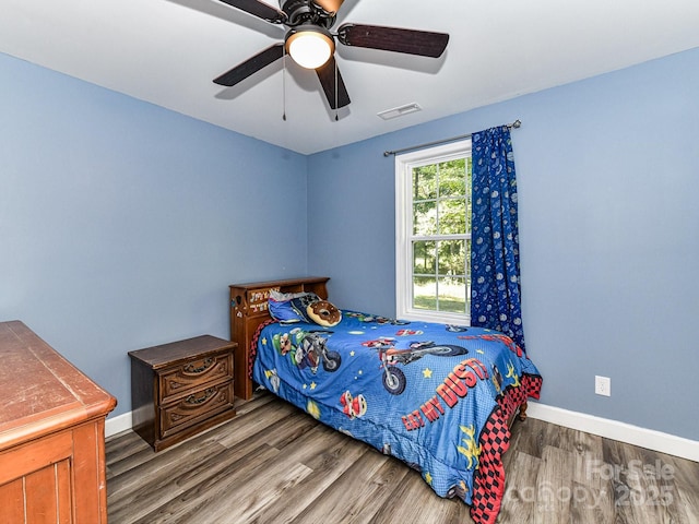 bedroom with ceiling fan and wood-type flooring