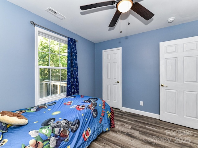 bedroom with ceiling fan and dark hardwood / wood-style floors