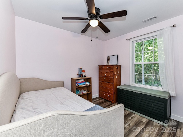 bedroom with ceiling fan and dark hardwood / wood-style floors