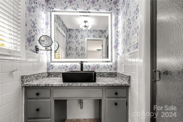 bathroom featuring tile walls and vanity