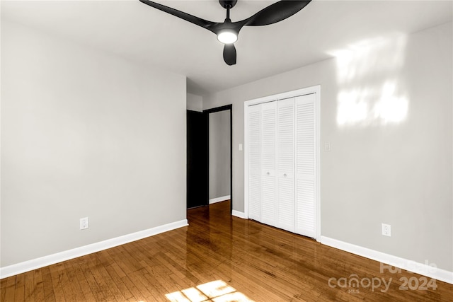 unfurnished bedroom with a closet, ceiling fan, and wood-type flooring