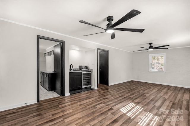 unfurnished living room with crown molding, ceiling fan, hardwood / wood-style flooring, and beverage cooler