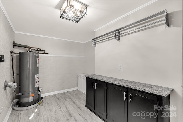 interior space featuring brick wall, gas water heater, light hardwood / wood-style flooring, and ornamental molding